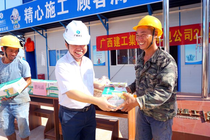 岑廷義為工人發(fā)放清涼慰問品。謝微旋 攝.jpg